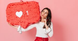 girl carrying instagram heart plush toy