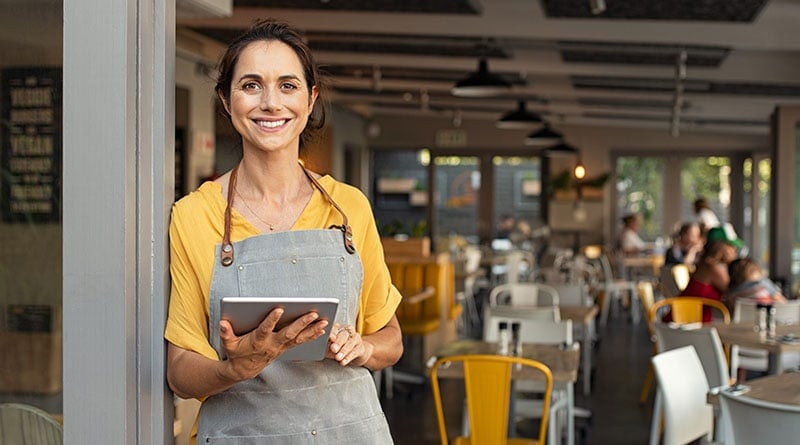 cafe owner looking at camera and smiling